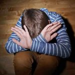 Shocking Exploitation: California’s “Kiddie Stroll” Uncovered A child sitting on the floor with their hands covering their face expressing distress