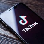 White House TikTok Stirs Unbelievable Celebrity Clash Phone screen showing TikTok logo and app