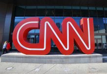 Profanity on Air: Crockett Sparks Congressional Chaos Large red CNN sign outside building entrance.