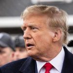 Epstein Bombshells Ignite Trump Firestorm Man in suit and red tie speaking outside.