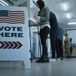 MASSIVE Voting Scandal — Foreign Mayor Exposed Sign reading Vote Here in a polling station