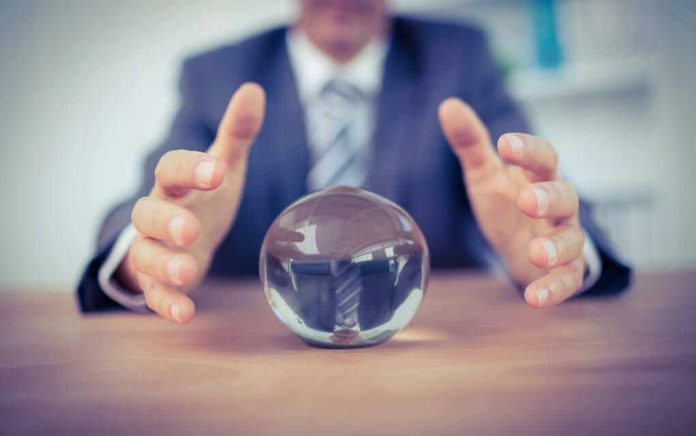 303688010 Man in suit reaching for crystal ball