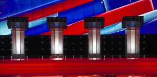 Four debate podiums on a CNN stage background