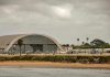 Aircraft hangar with helicopters near the beach.