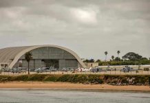 Trump Designates New Militarized Zone in this State Aircraft hangar with helicopters near the beach.