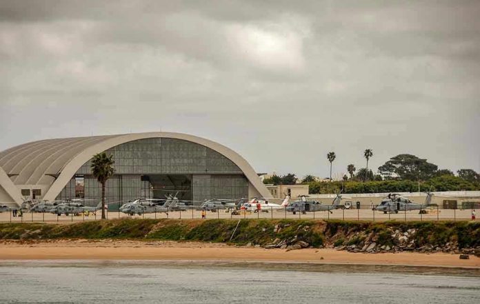 Aircraft hangar with helicopters near the beach.