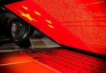 Beijing’s Warning Shot BACKFIRES Laptop screen displaying Chinese flag and code.