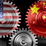 Beijing Panics As America-First Tariffs Bite Interlocking gears with USA and China flags.