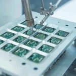 Revolutionary Chip Tech Shocks Industry Robotic arm assembling electronic circuit boards in production.