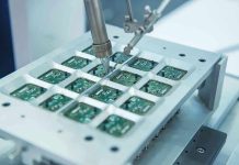 Revolutionary Chip Tech Shocks Industry Robotic arm assembling electronic circuit boards in production.