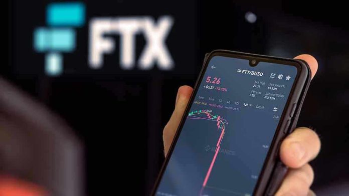 Hand holding phone with FTX trading app.