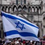 Israel Eurovision Scandal: Nations Walk Out Israeli flag at a crowded outdoor event.