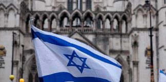Israeli flag at a crowded outdoor event.