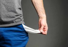 Person pulling out empty pocket from shorts.