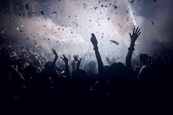 420455902 Crowd celebrating under confetti and bright lights.