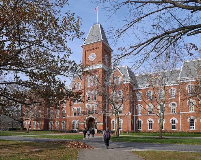 Historic university building with students walking in front during autumn