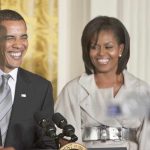 Former President Barack Obama and Michelle Obama smiling at a public event