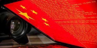 China Seized Critical AI Advantage Laptop screen displaying Chinese flag and code.