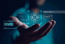 Hand holding digital AI and ChatGPT graphics.