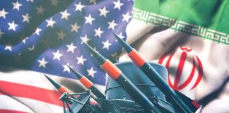 Iran and USA flags with missile launcher.