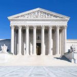 DOJ Subpoenas SHOCK WSJ – Press Freedoms at Risk! The Supreme Court building featuring marble columns and a clear blue sky
