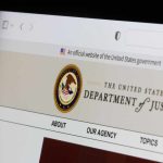Close-up of the U.S. Department of Justice website on a computer screen