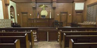Hidden Pills, Lost Pregnancy, LIFE Sentence Interior view of an empty courtroom with wooden benches and a judges bench