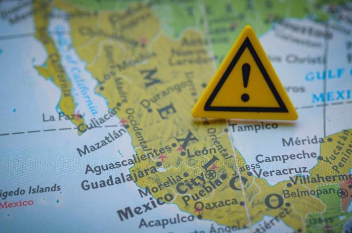 A close-up of a map of Mexico with a yellow warning sign placed on it