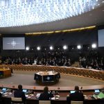 Conference room with large round table and attendees