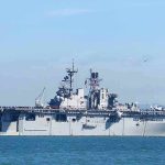Aircraft carrier sailing on calm blue water