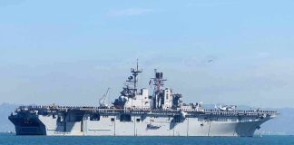 Aircraft carrier sailing on calm blue water