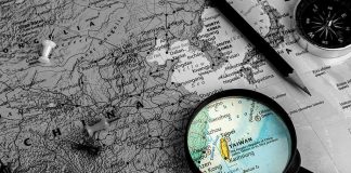 Red Terror Warning Shocks Taiwan Magnifying glass highlighting Taiwan on a map