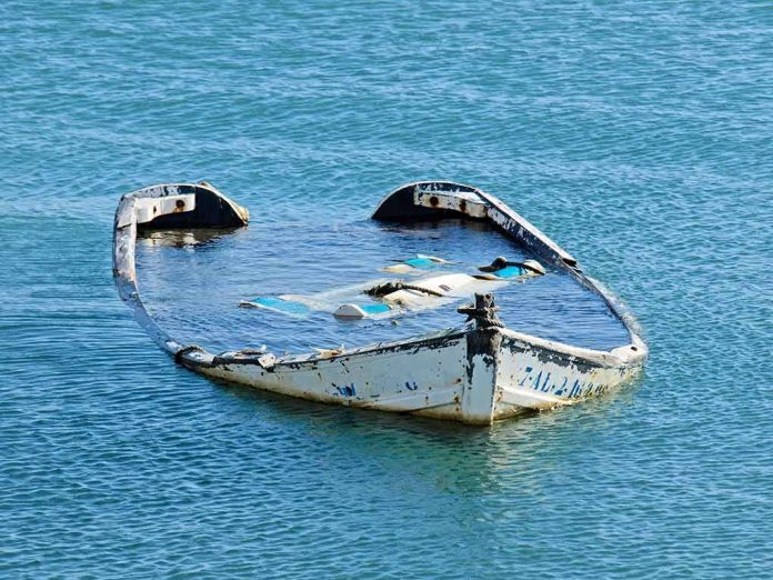 partially sunken boat in calm blue water
