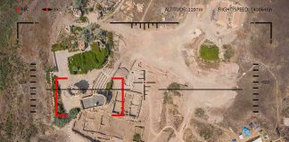 Iran Missiles Slam U.S. Base Aerial view through drone HUD of archaeological ruins and surrounding campsite