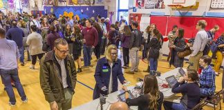 USPS Gatekeeper? Ballots Blocked by Barcodes Crowd at check-in tables inside a gymnasium