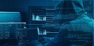 Hooded person at multiple computer screens with code and charts