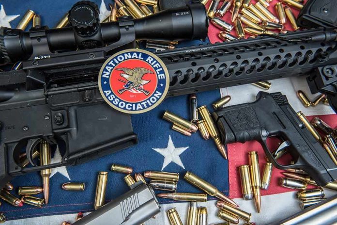 Rifles and pistol with ammunition on American flag