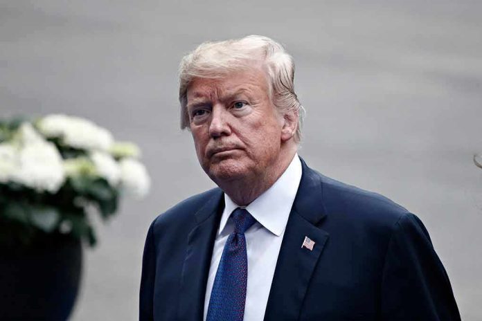 man in a suit with an American flag pin