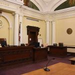 Privilege Bombshell: Navarro Left Without Trump empty courtroom with judge's bench and columns
