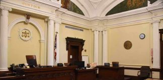 empty courtroom with judge's bench and columns