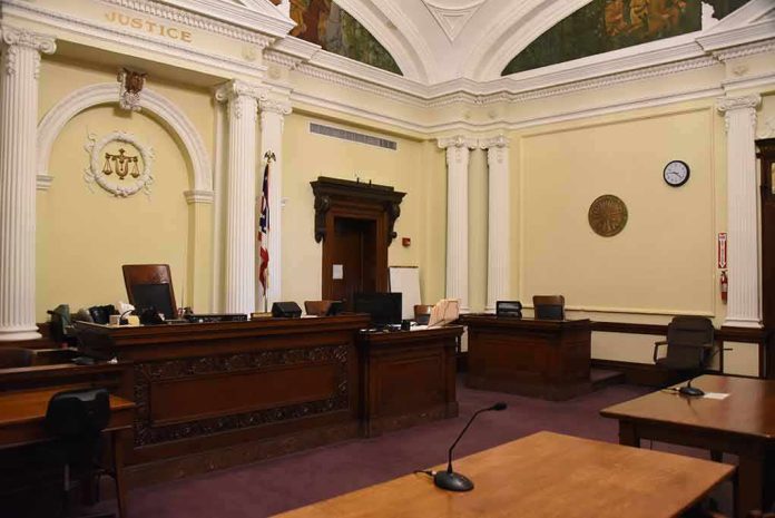 shutterstock_1292266861 empty courtroom with judge's bench and columns