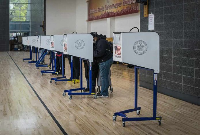 shutterstock_1846768891 Voters at polling booths in a gymnasium