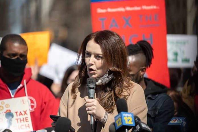Woman speaking into a microphone at a rally