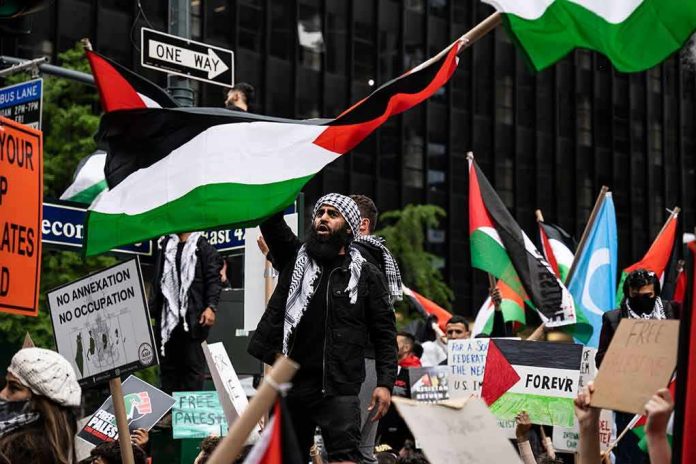 shutterstock_1973000603 Protesters wave Palestinian flags at a city demonstration