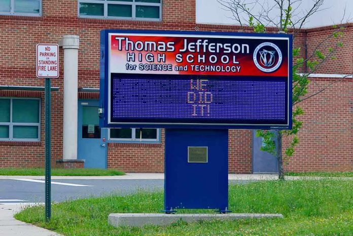 Electronic school marquee in front of a brick high school