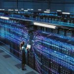 AI Data Centers Are Coming for MORE Electricity Technician with laptop in a large data center aisle