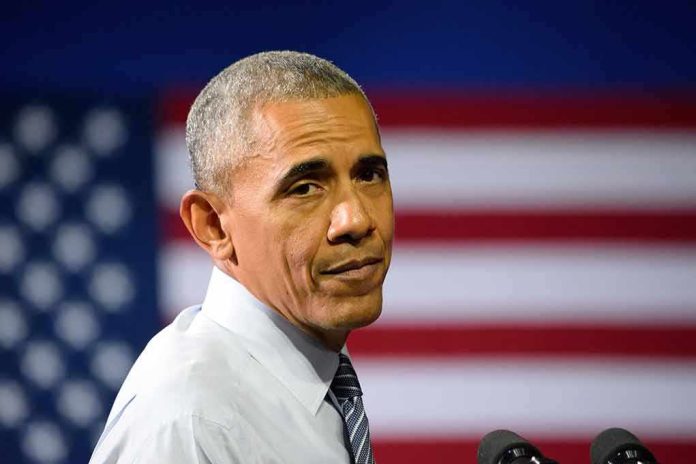 man speaking at podium with american flag backdrop