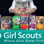 Girl Scouts Introduces ‘PILLARS OF ISLAM’ Badges Girl Scout displays assorted cookie boxes on a table