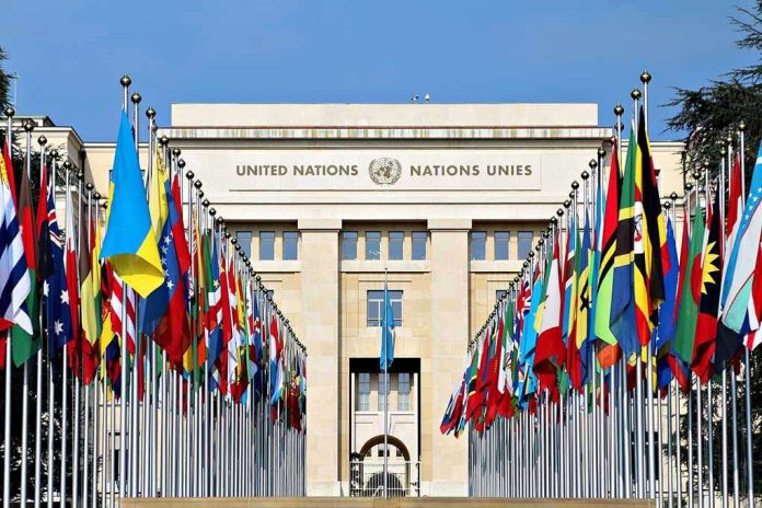 423802144-2 United Nations building with numerous national flags outside.
