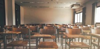 Biden Era Title IX Rule Officially RESCINDED Empty classroom with rows of wooden desks and chairs